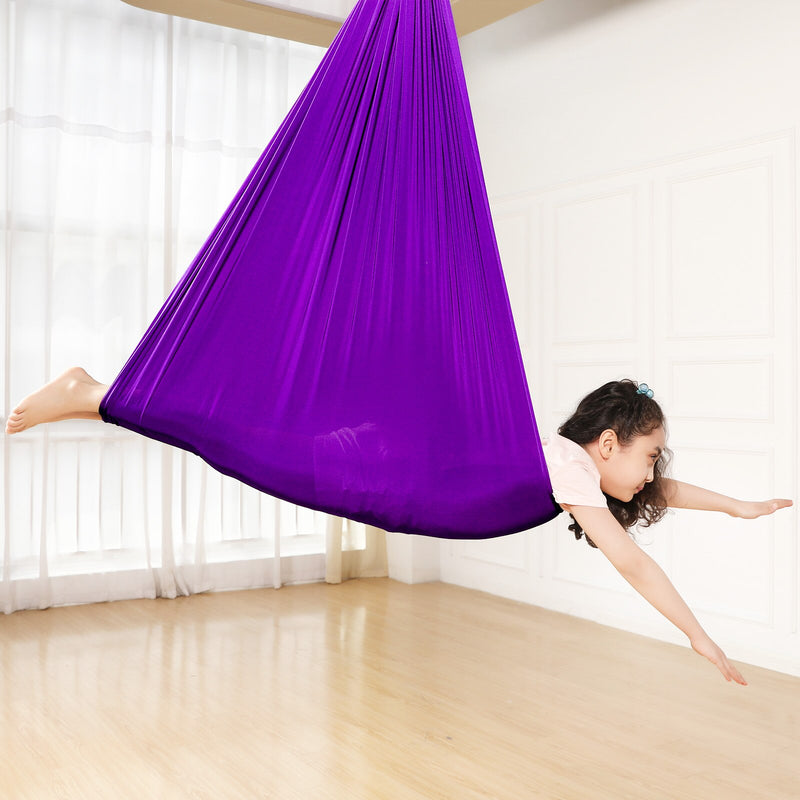 a girl pretending she is flying inside the Therapy Sensory Swing Hammock Chair